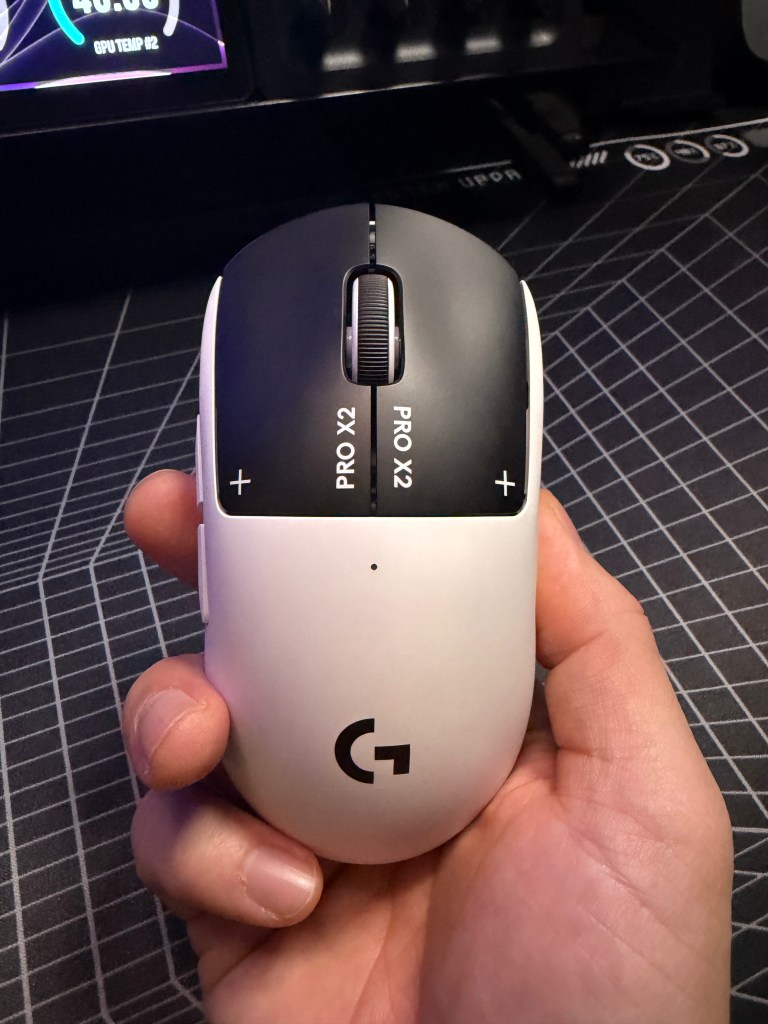 Logitech Pro X2 Superstrike mouse in hand